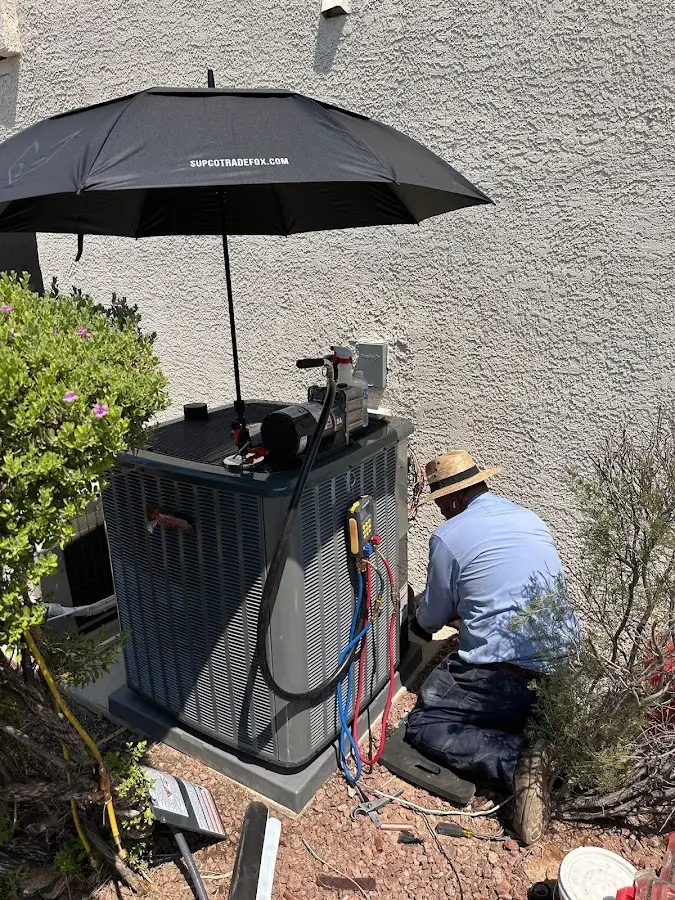 HVAC technician performing outdoor AC maintenance in Belle Isle